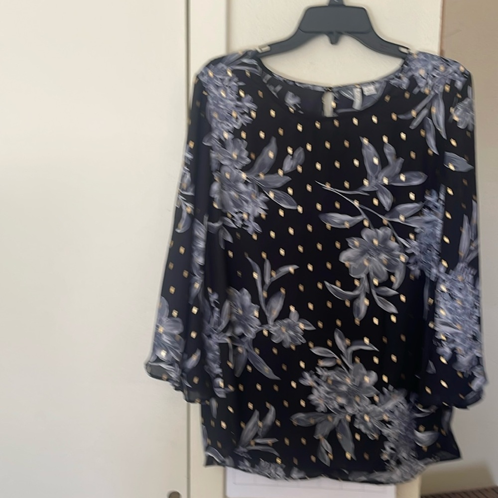Ladies silky top with gold accents and gray floral pattern. Flared sleeves